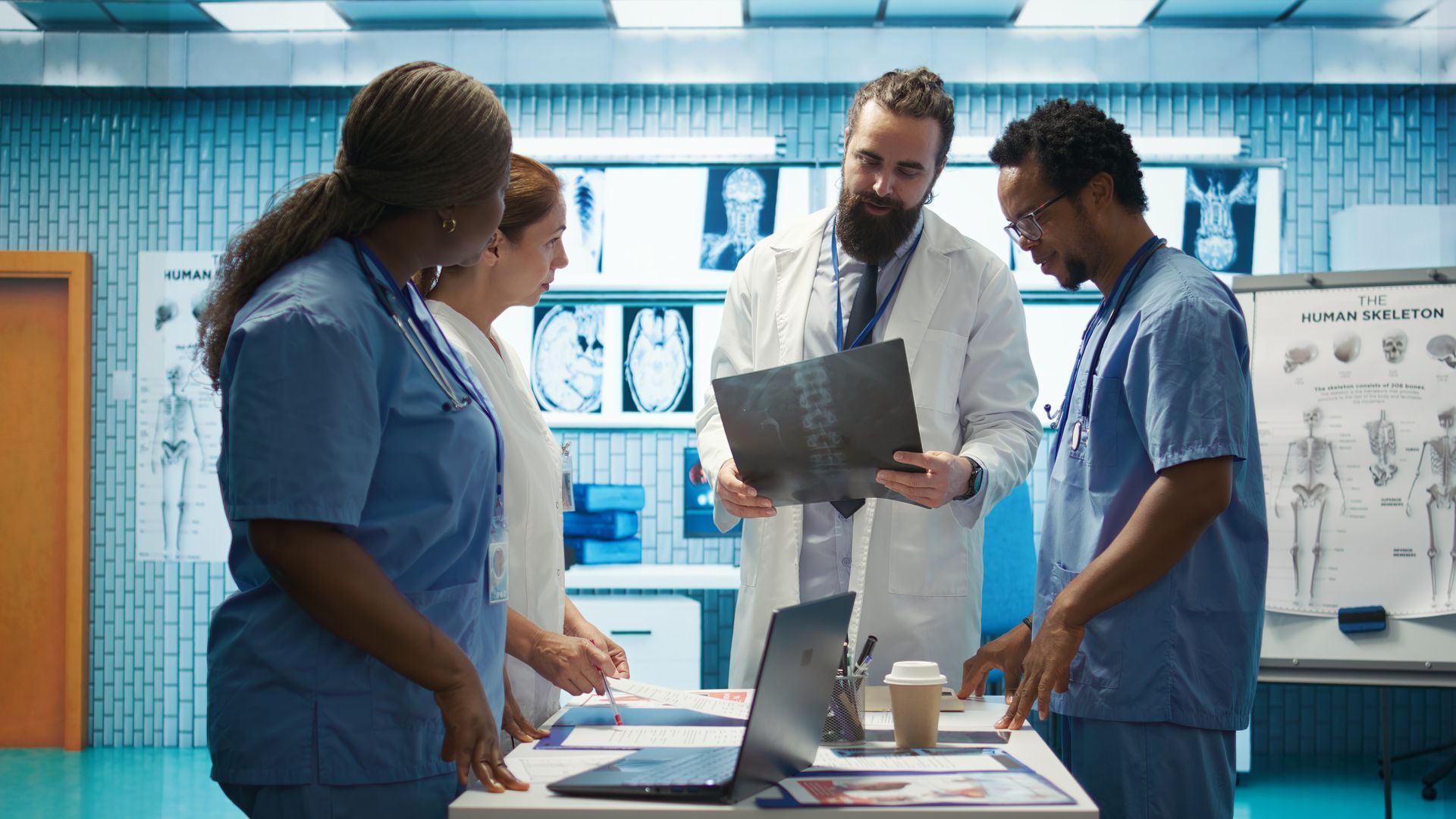Medical professionals reviewing an X-ray in a hospital room.