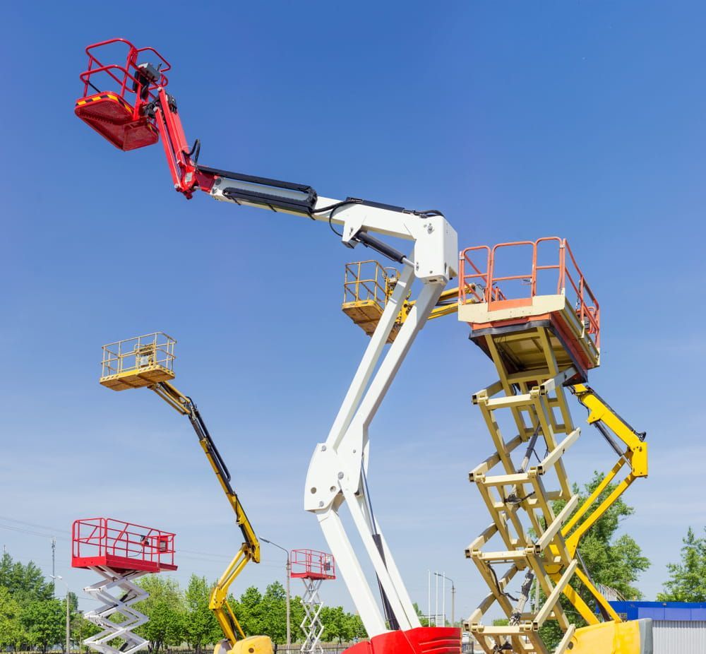 Three Scissor Lifts are Parked next to Each Other on a Sunny Day — Innisfail Auto Electrics Pty Ltd in Babinda, QLD