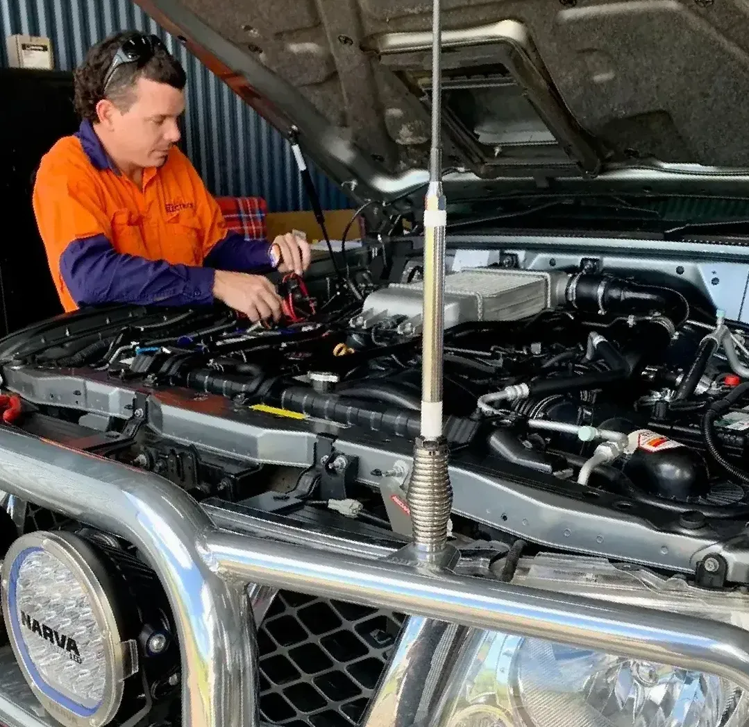 Technician Man Using Analog Multimeter — Innisfail Auto Electrics Pty Ltd in Mundoo, QLD