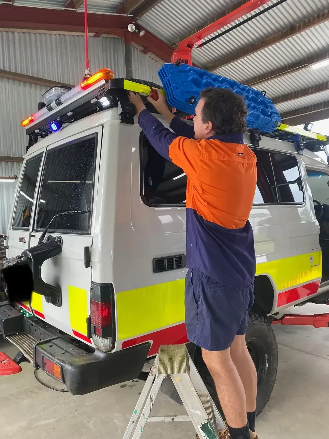 Auto Mechanic Worker Hands Installing Roof Racks — Innisfail Auto Electrics Pty Ltd in Mundoo, QLD
