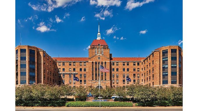 A large brick building with a clock tower on top of it.