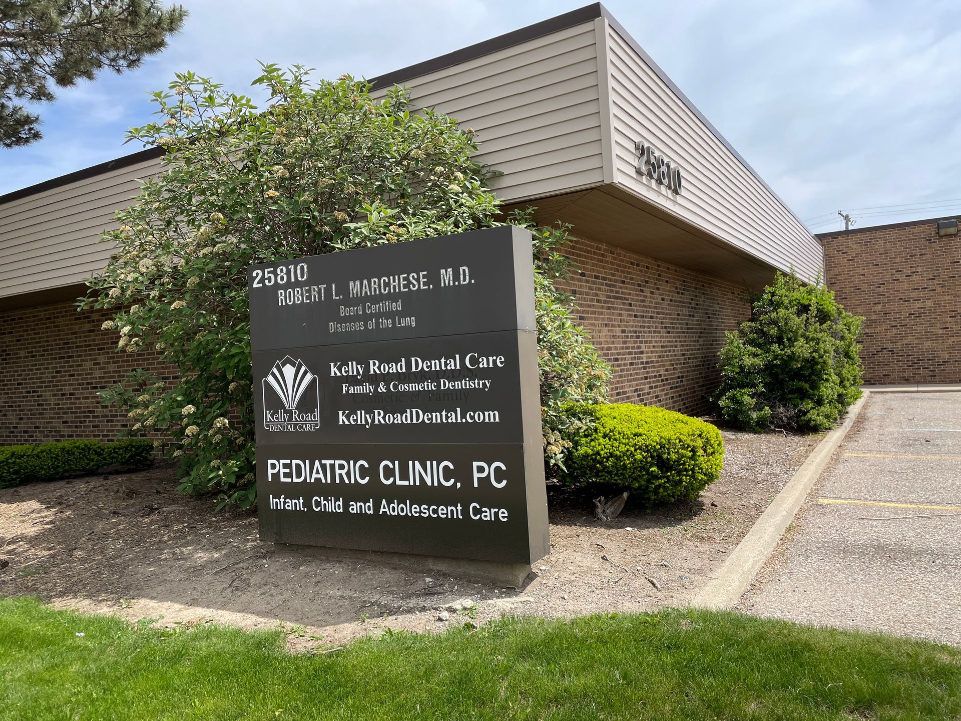 A sign for a pediatric clinic is in front of a building.