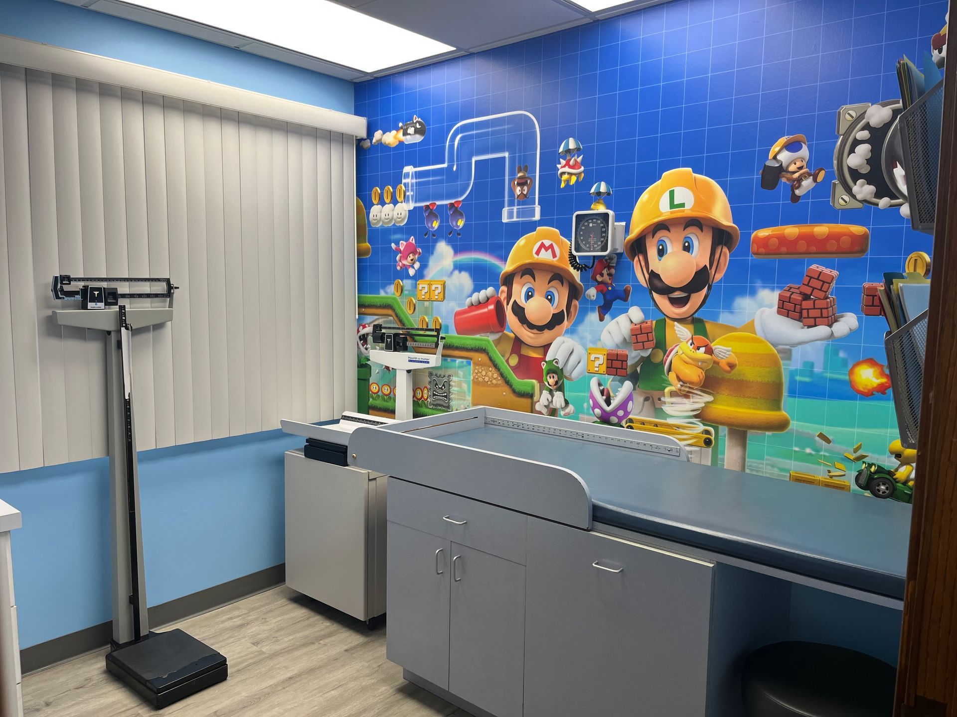 A doctor 's office with a mural of mario and luigi on the wall.