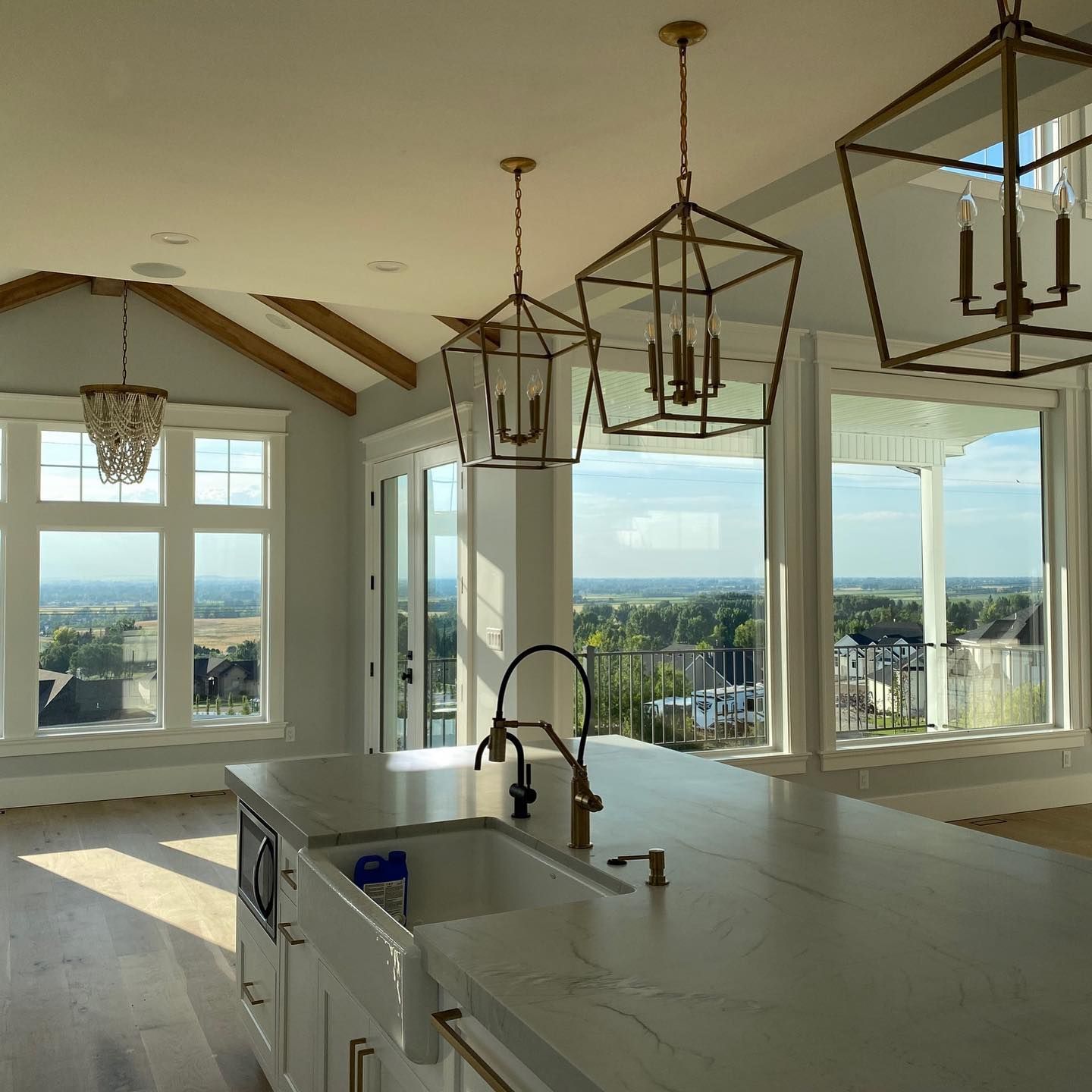 A kitchen with a sink and lanterns hanging from the ceiling