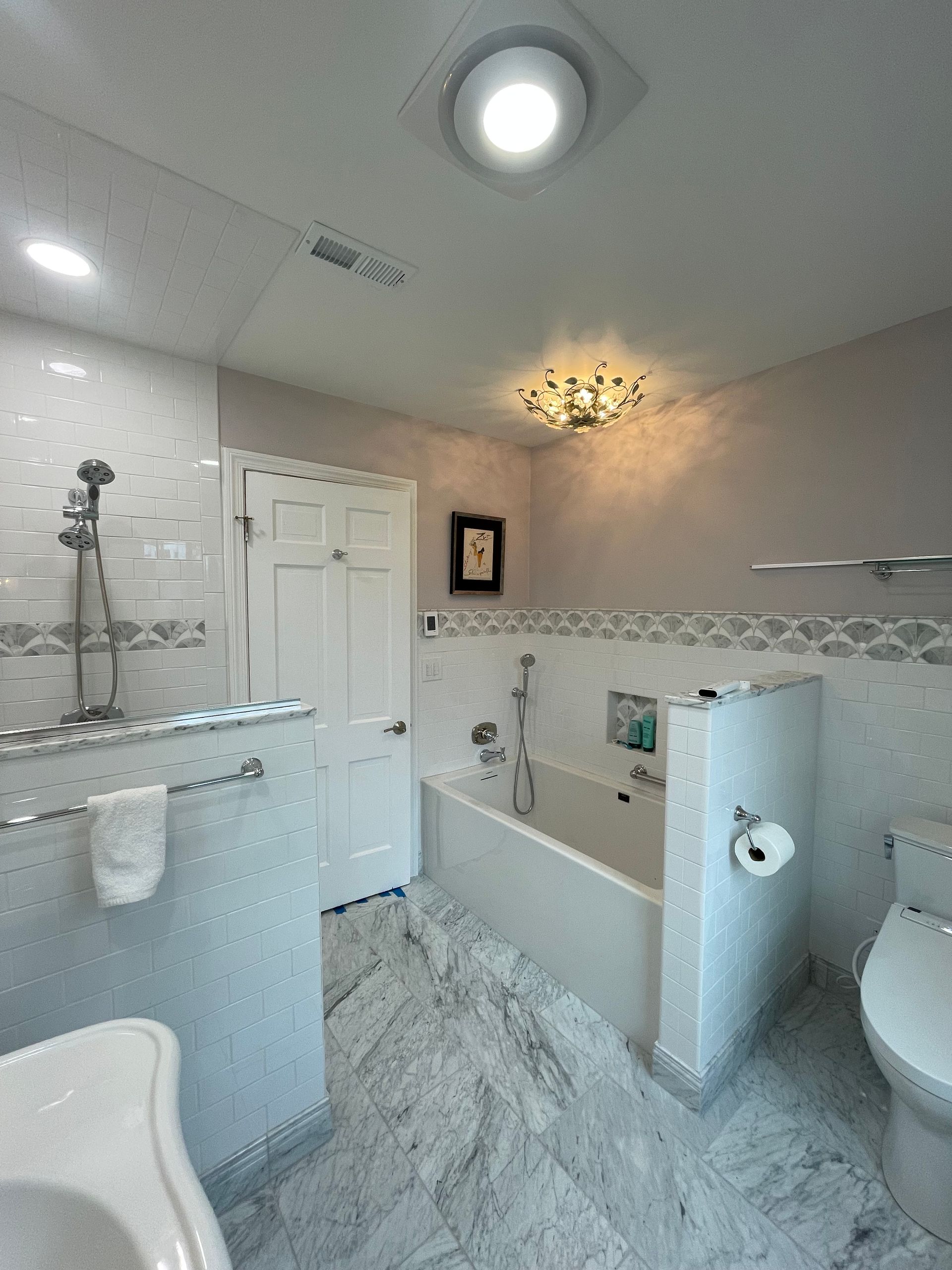 A bathroom with a sink , toilet and bathtub