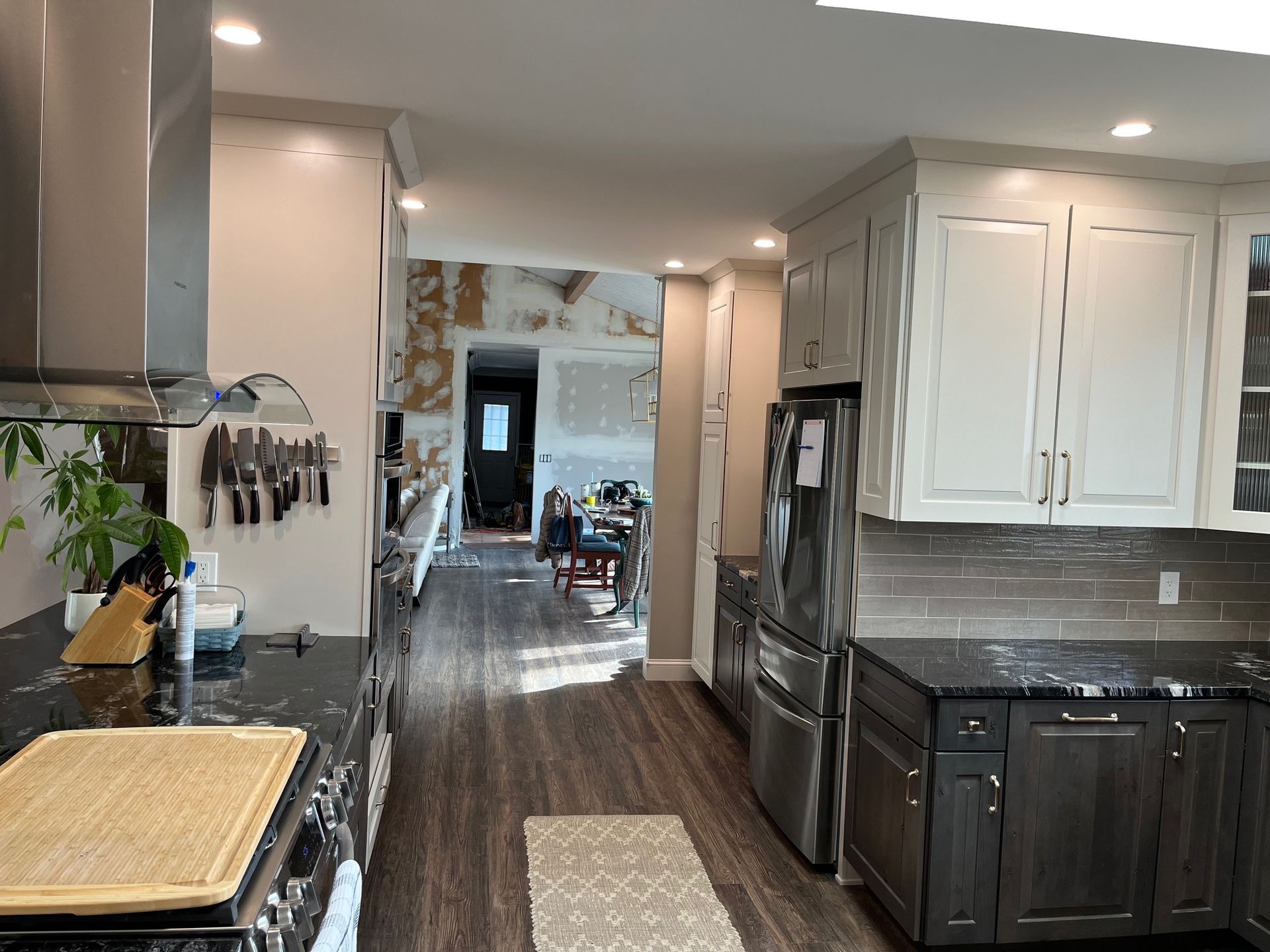 A kitchen with stainless steel appliances and white cabinets.
