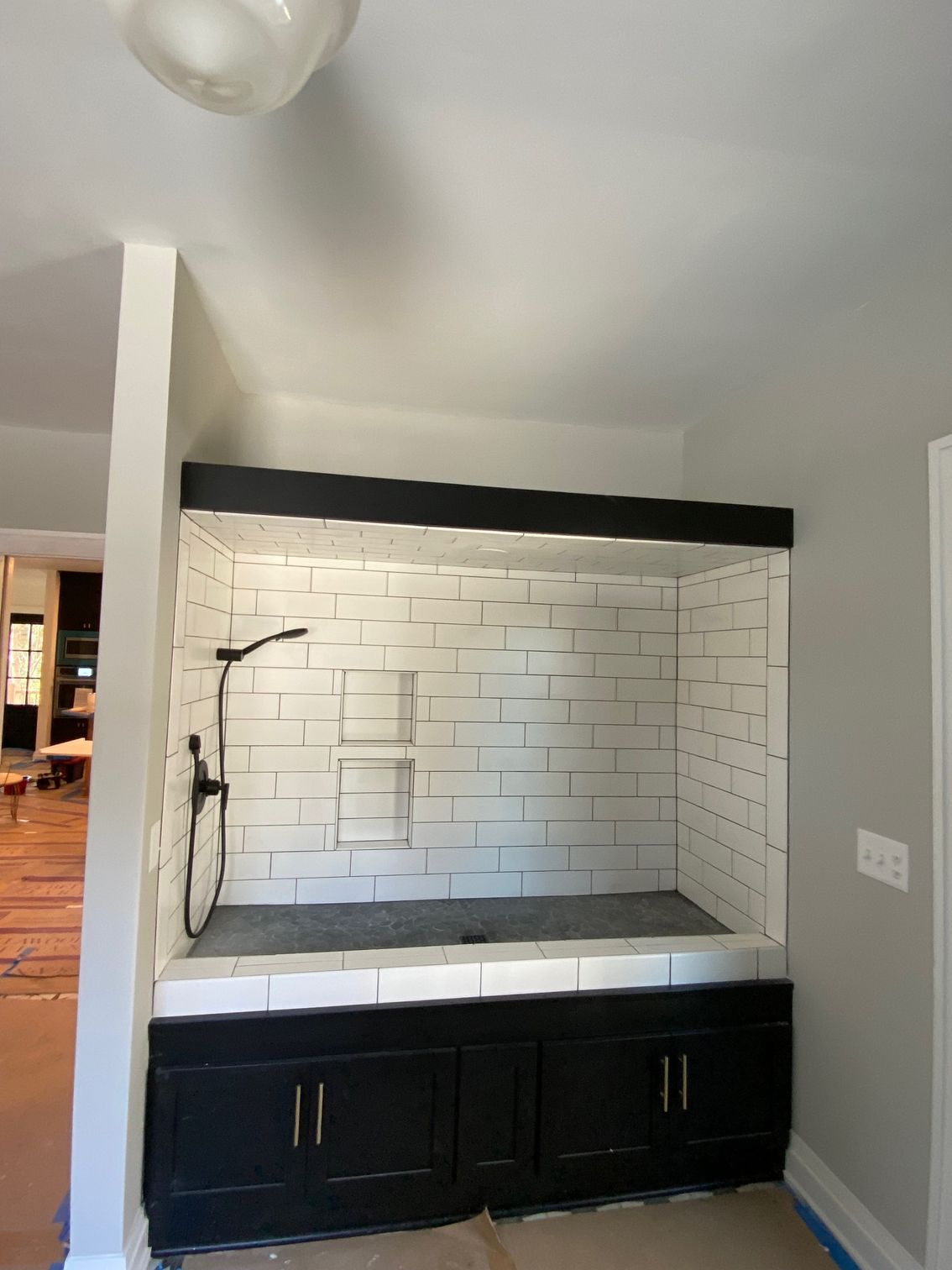 A bathroom with a bathtub and a shower head