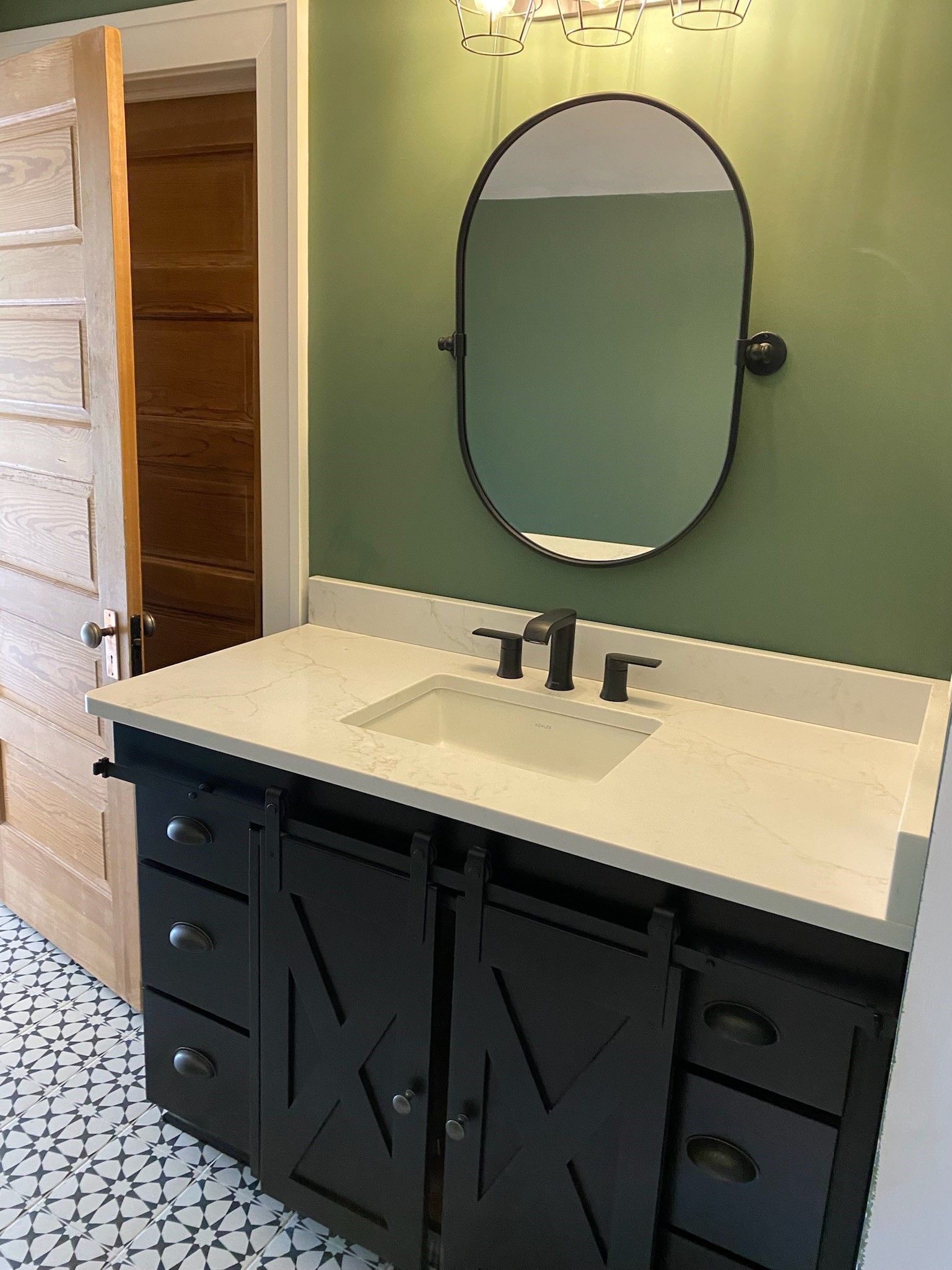 A bathroom with a sink and a mirror on the wall