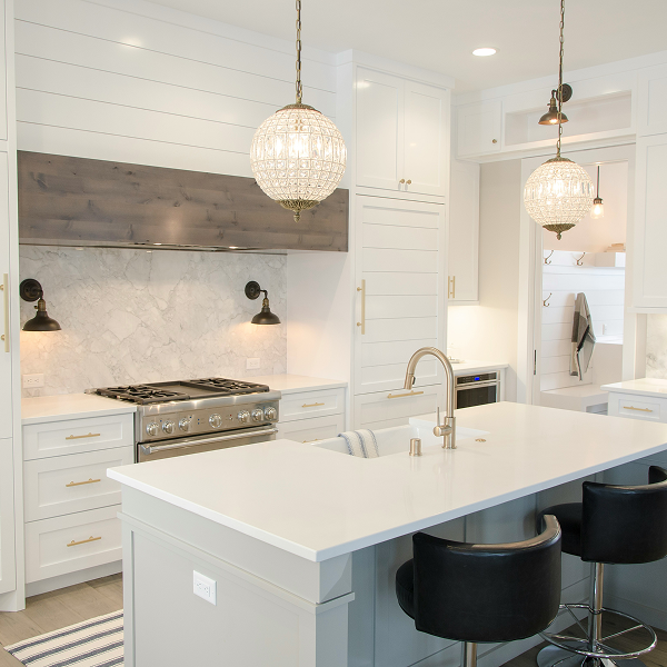 A kitchen with blue cabinets and a stove top oven