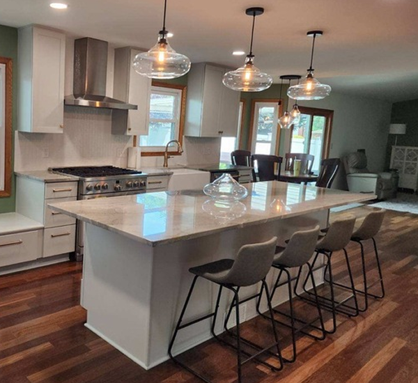 A kitchen with blue cabinets and a stove top oven