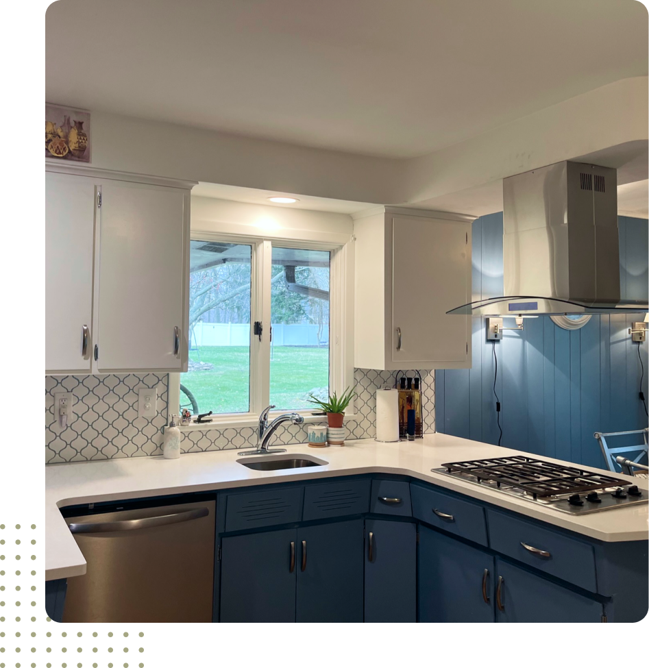 A kitchen with blue cabinets and a stove top oven