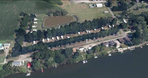 A row of white recreational vehicles parked on a paved lot.