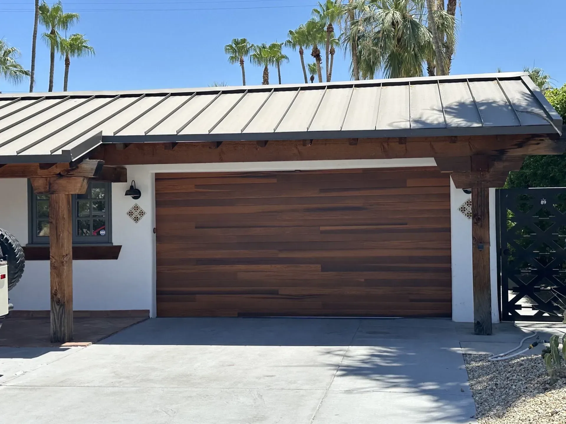 A garage with a wooden door and a metal roof