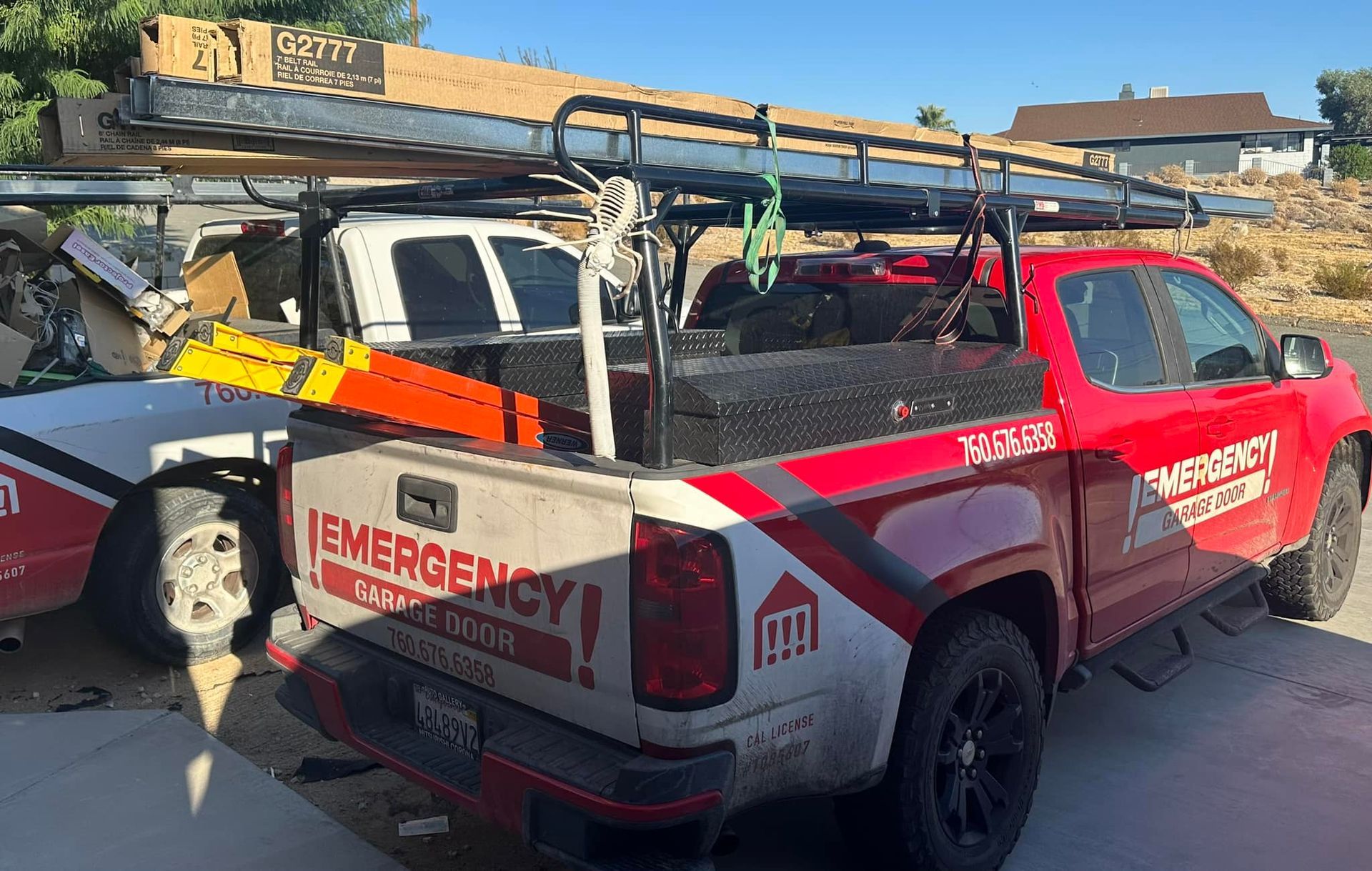 A red and white emergency truck is parked in a driveway.