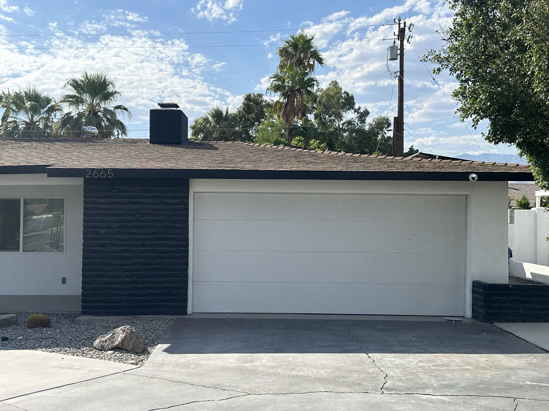 The front of a house with a white garage door