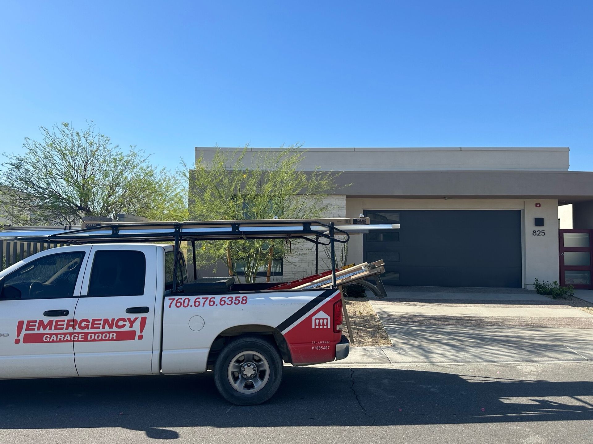 A white emergency truck is parked in front of a house.