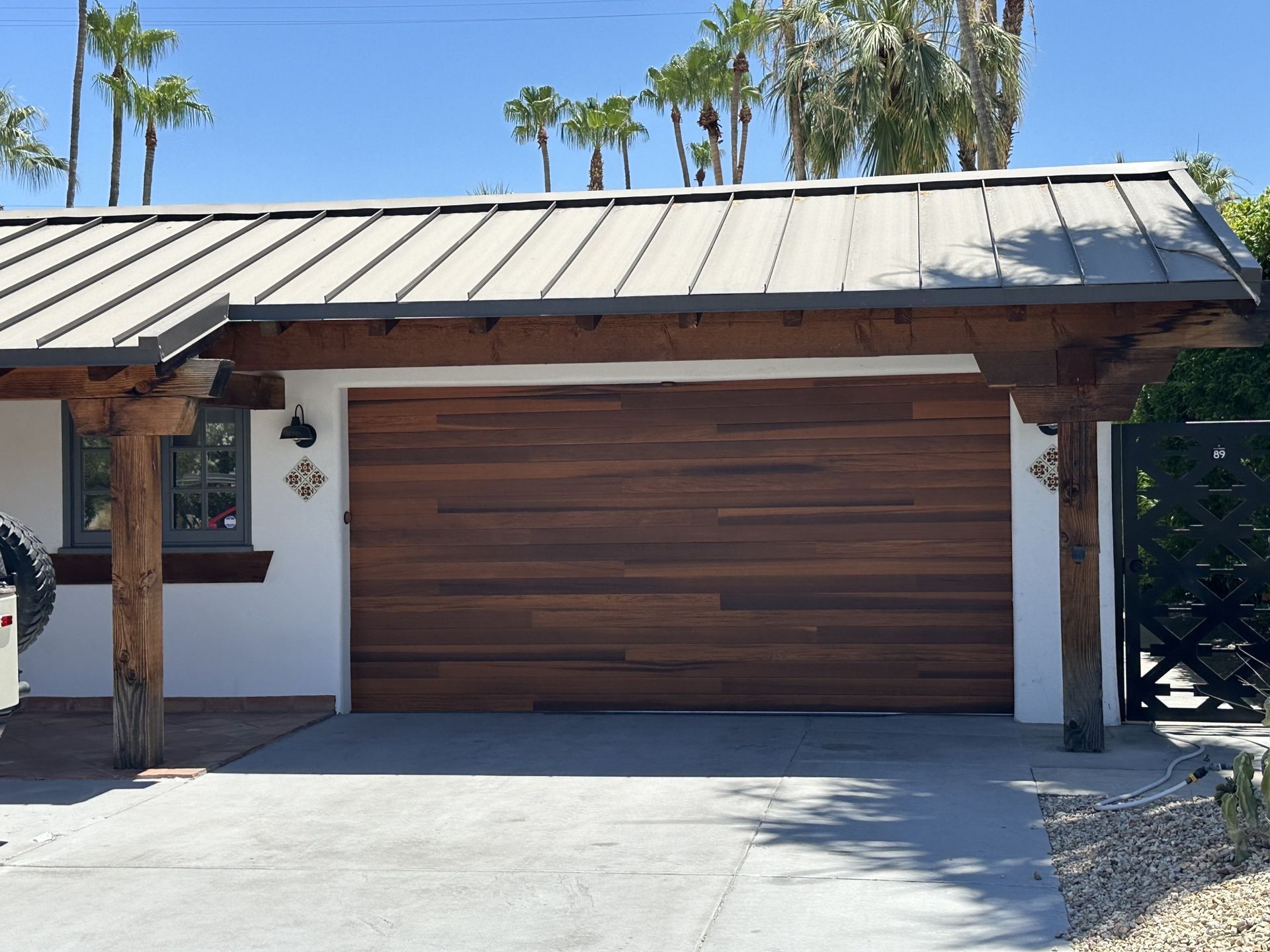 A garage with a wooden door and a metal roof