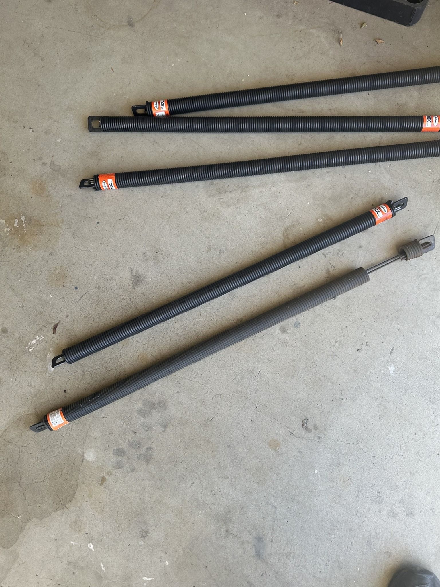 A bunch of drill bits are laying on the ground.