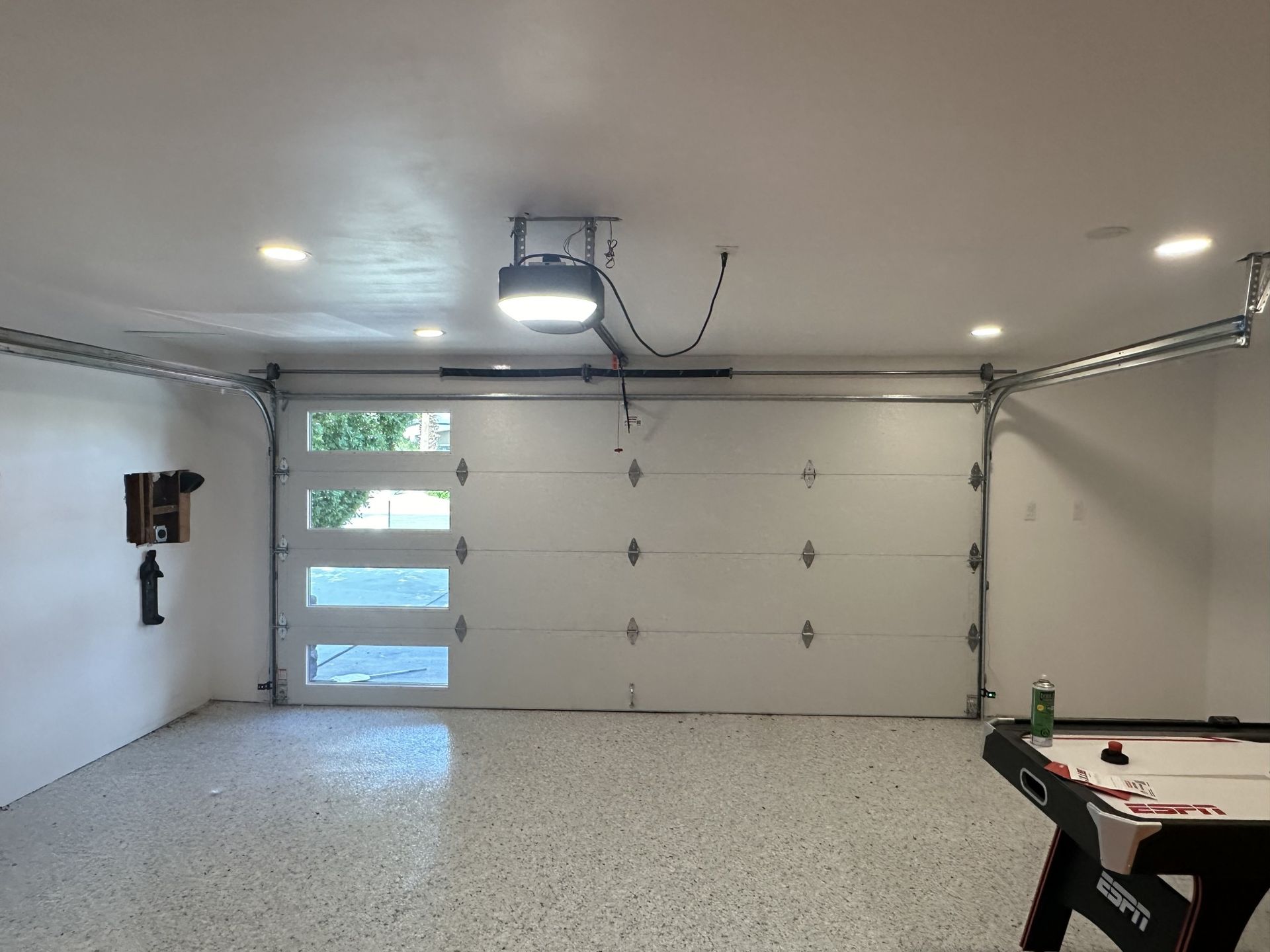 An empty garage with a pool table in it