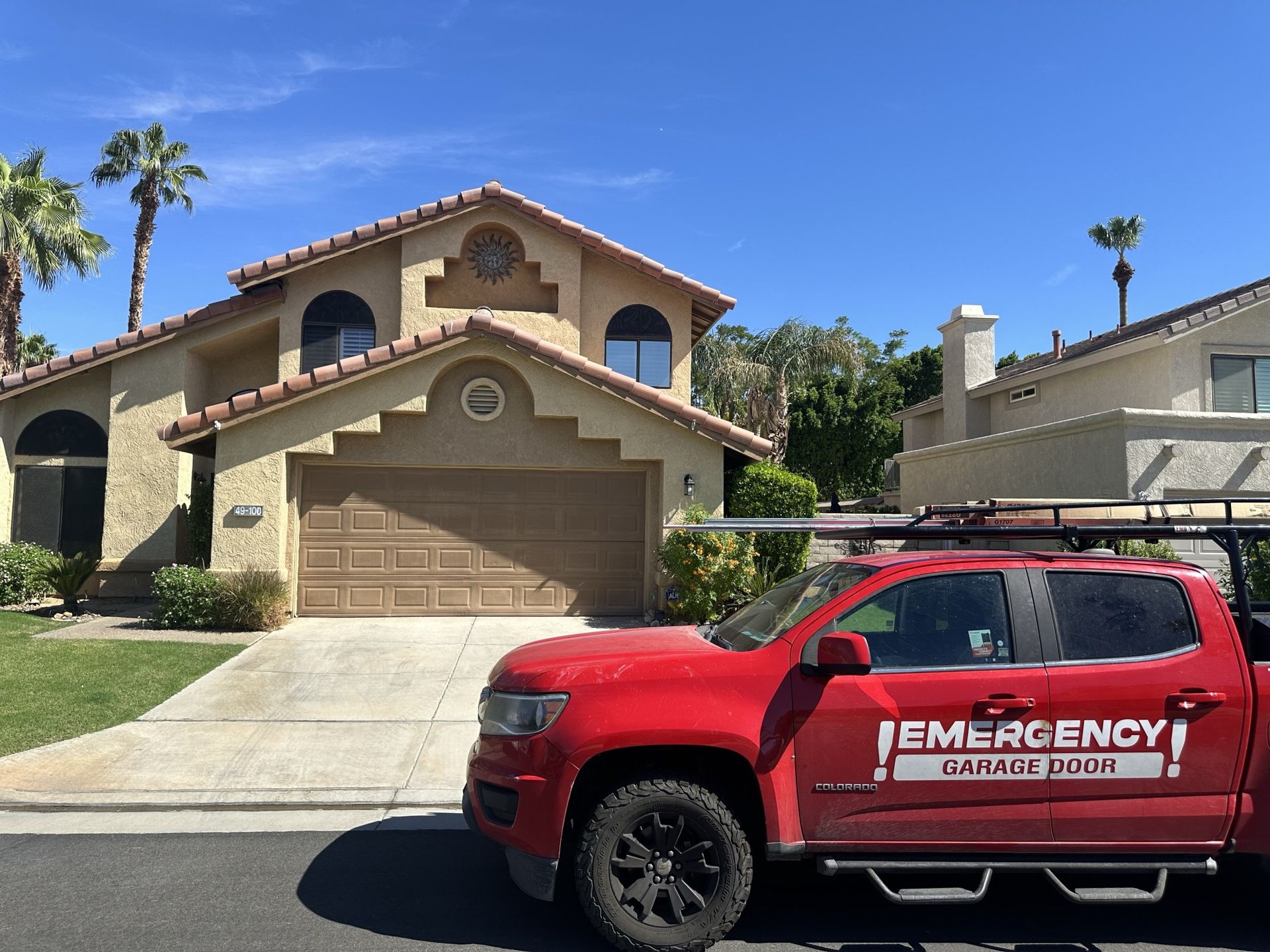 A red emergency vehicle is parked in front of a house.