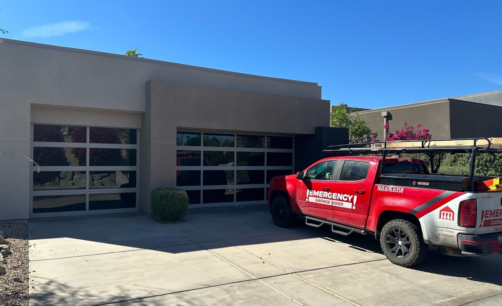 A red truck is parked in front of a house.