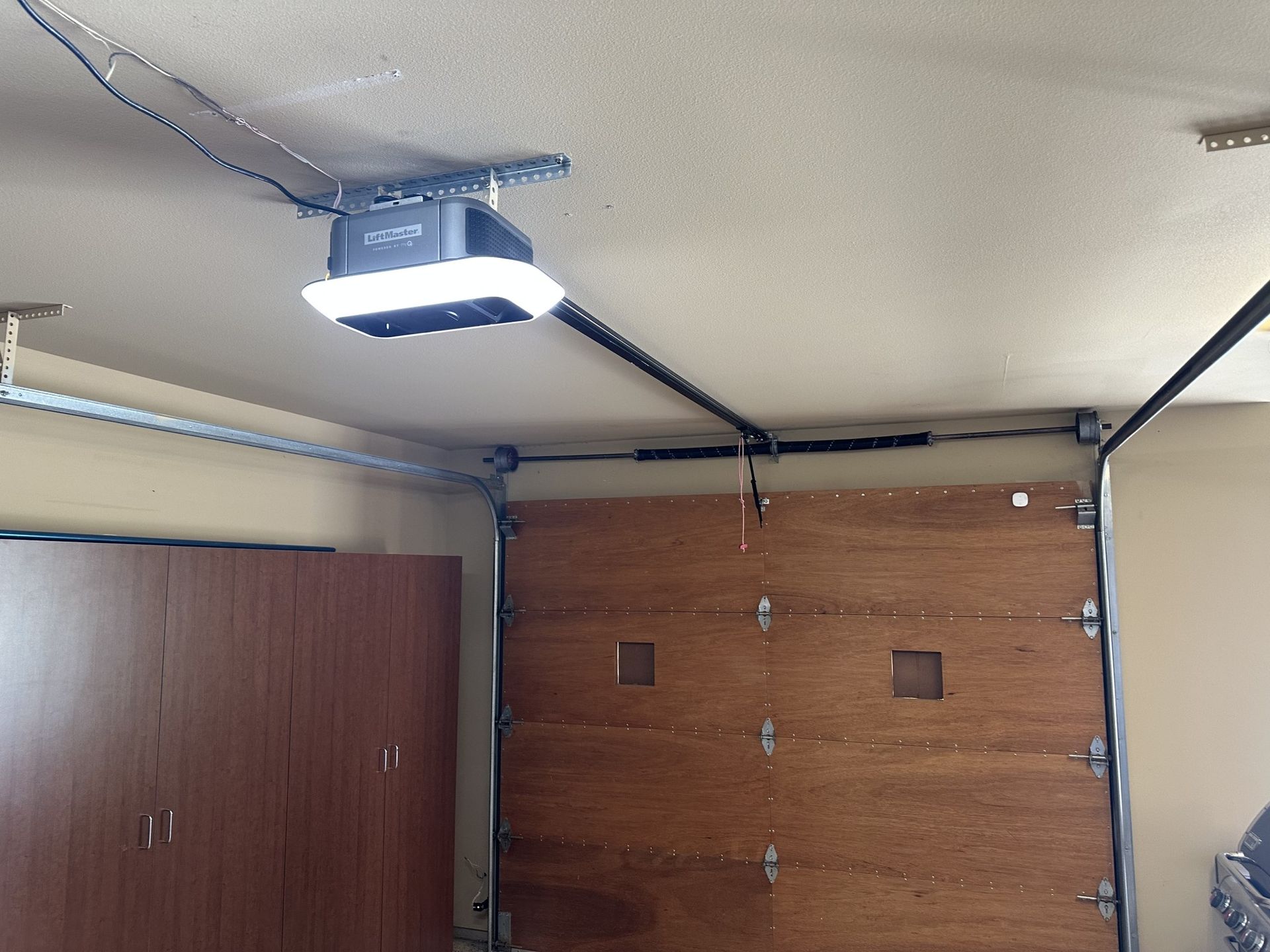 A garage door opener is hanging from the ceiling
