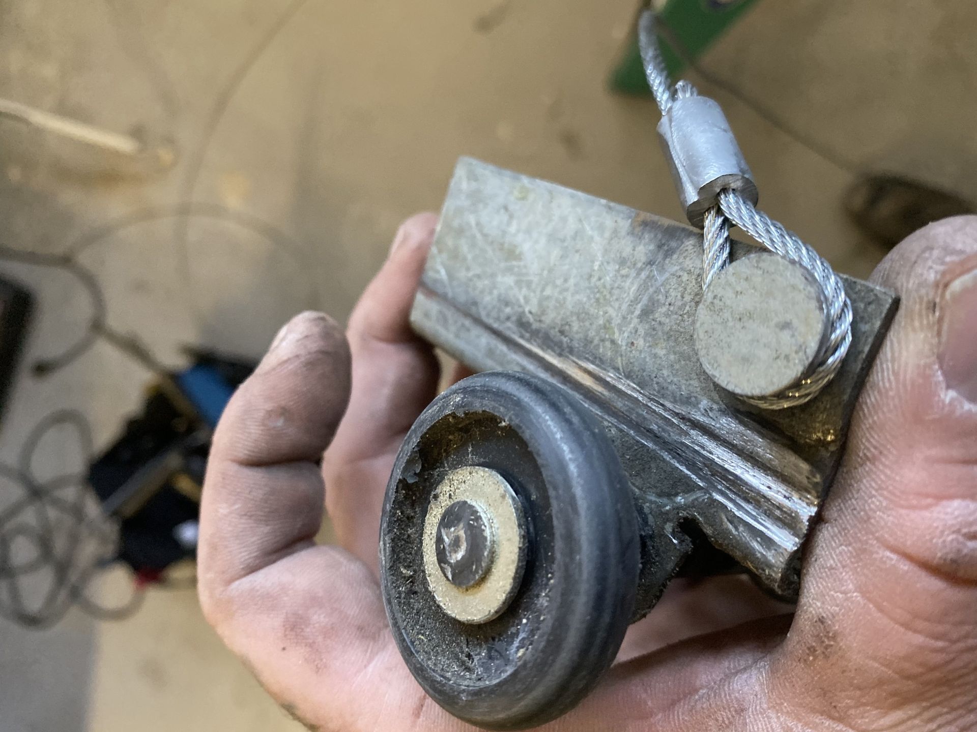 A person is holding a piece of metal in their hand