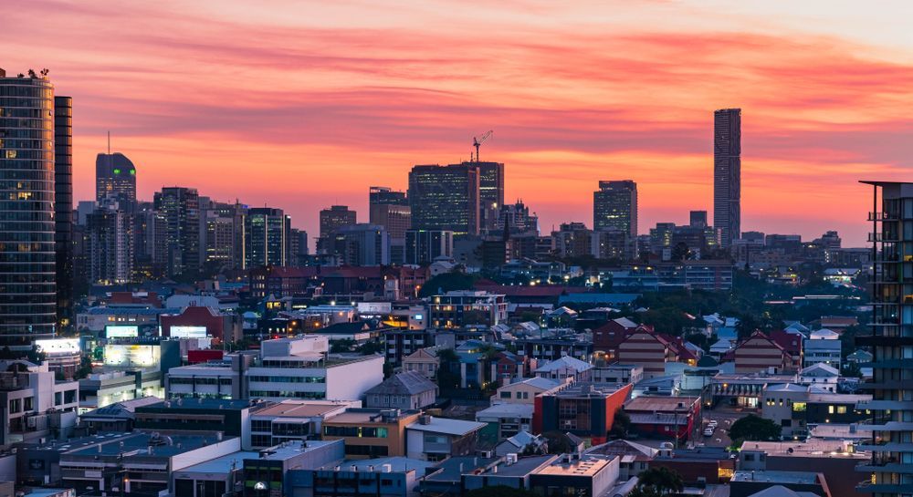 City Skyline at Sunset With Pink-orange Sky and Glowing Buildings — Auto Maniac in Mareeba, QLD