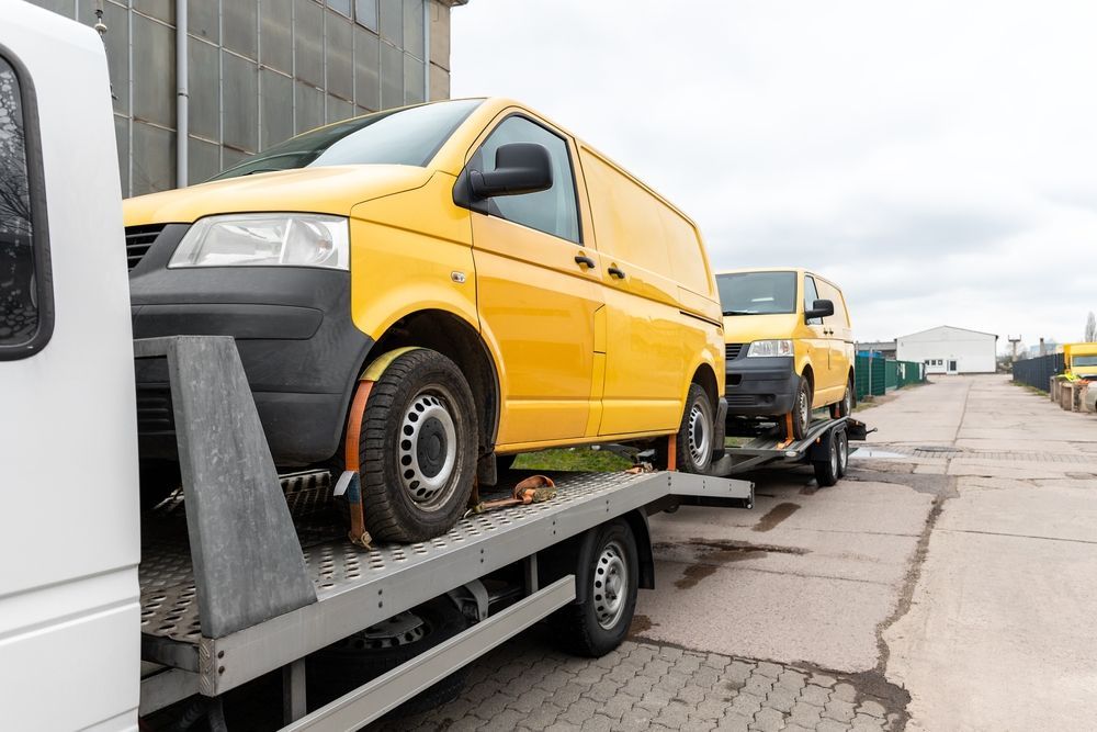 Yellow Cargo Vans Loaded on a Flatbed Trailer — Auto Maniac in Mossman, QLD