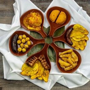There are many different types of food in the bowls on the table.