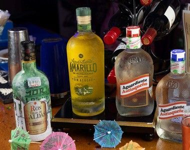 A table with bottles of alcohol and umbrellas on it