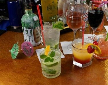 A table topped with a variety of drinks and bottles.