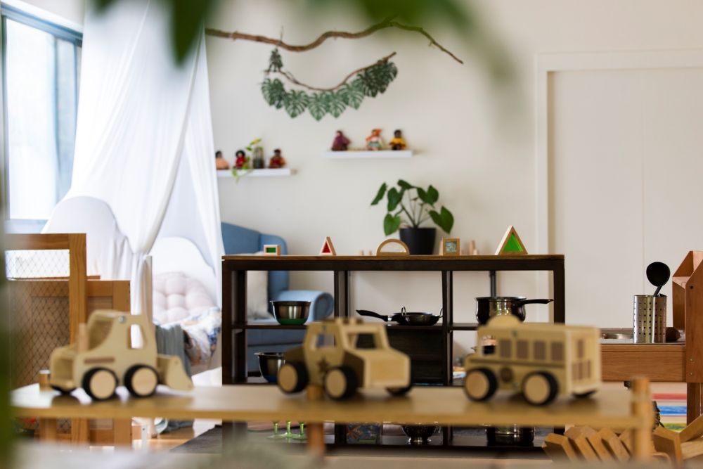 A play room with a lot of wooden toys on a table at Discover Early Learning.