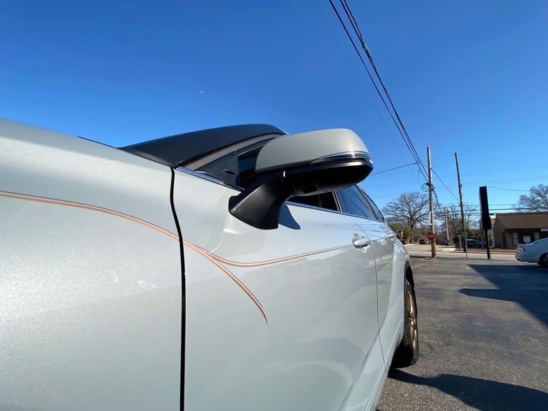 A white car is parked on the side of the road