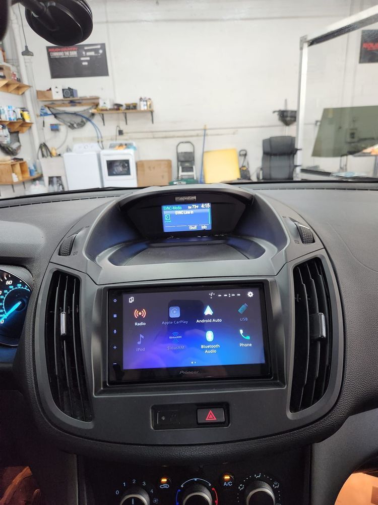 The dashboard of a car with a pioneer radio