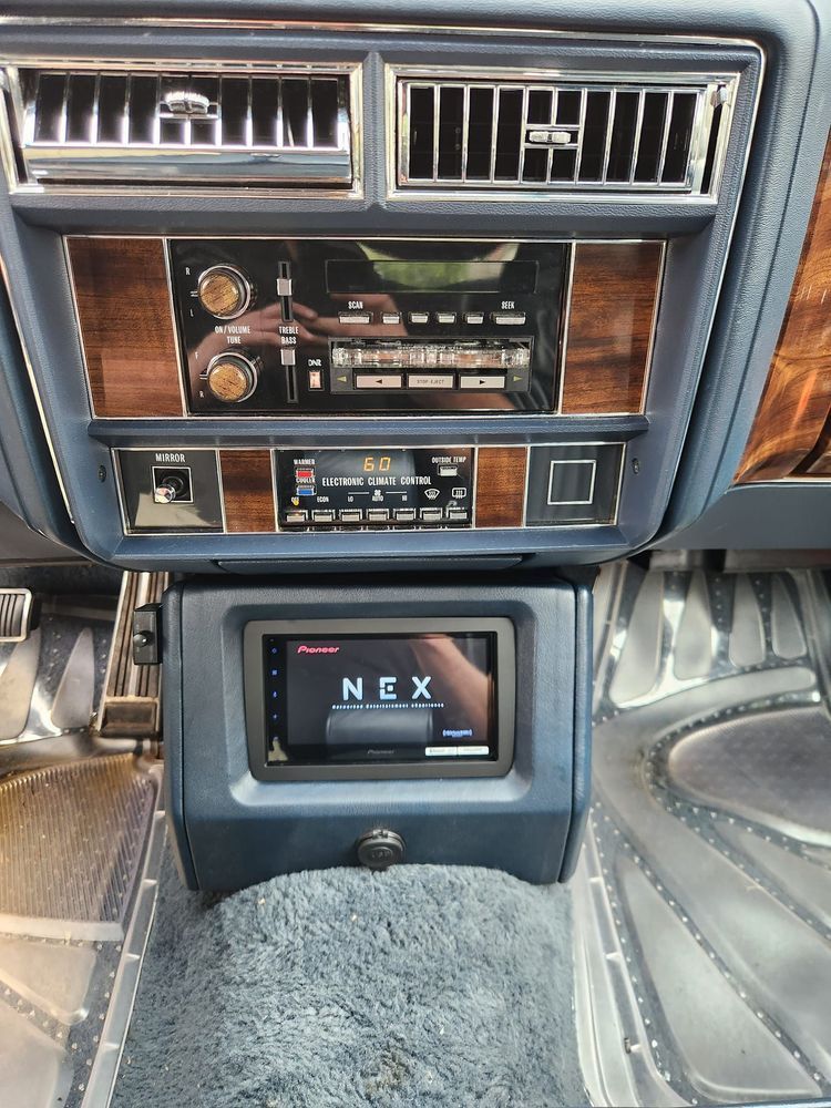 The dashboard of a car with a pioneer radio.
