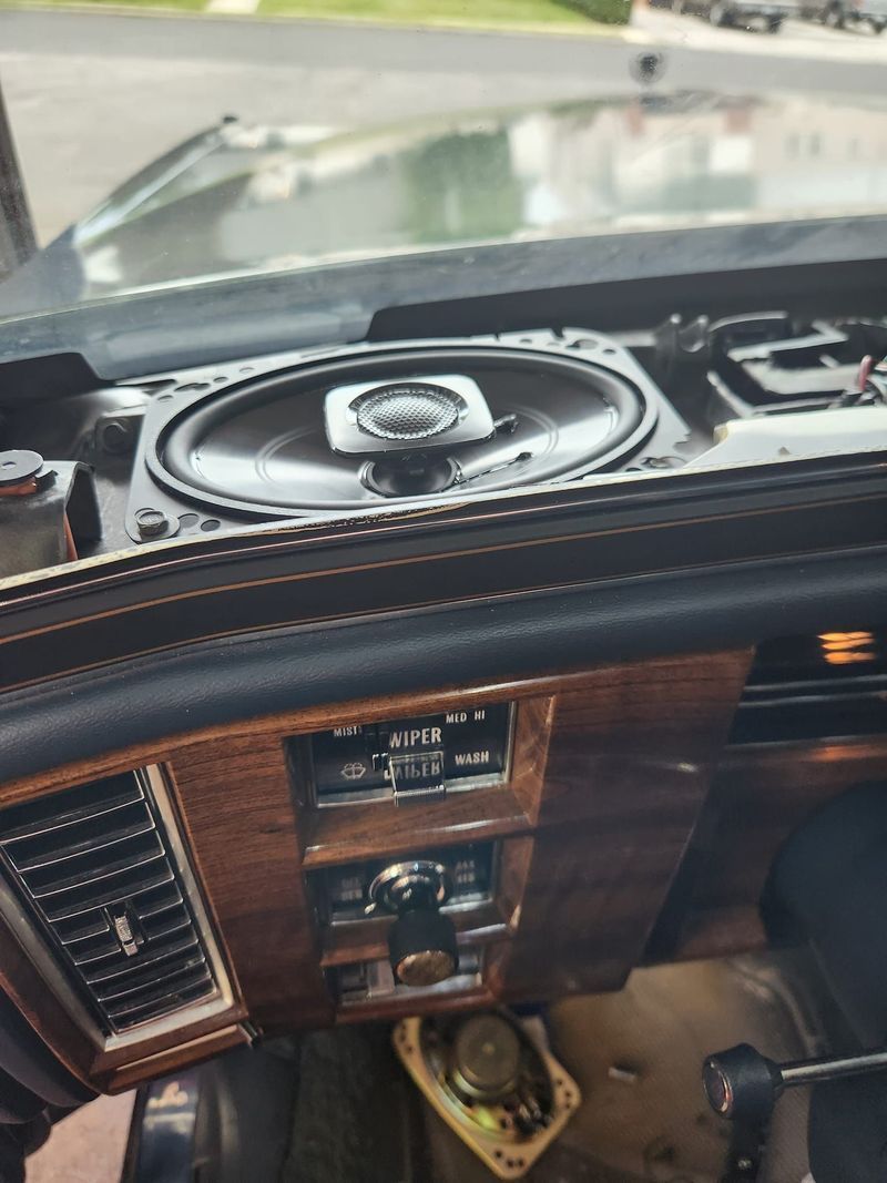 A car dashboard with a speaker on top of it