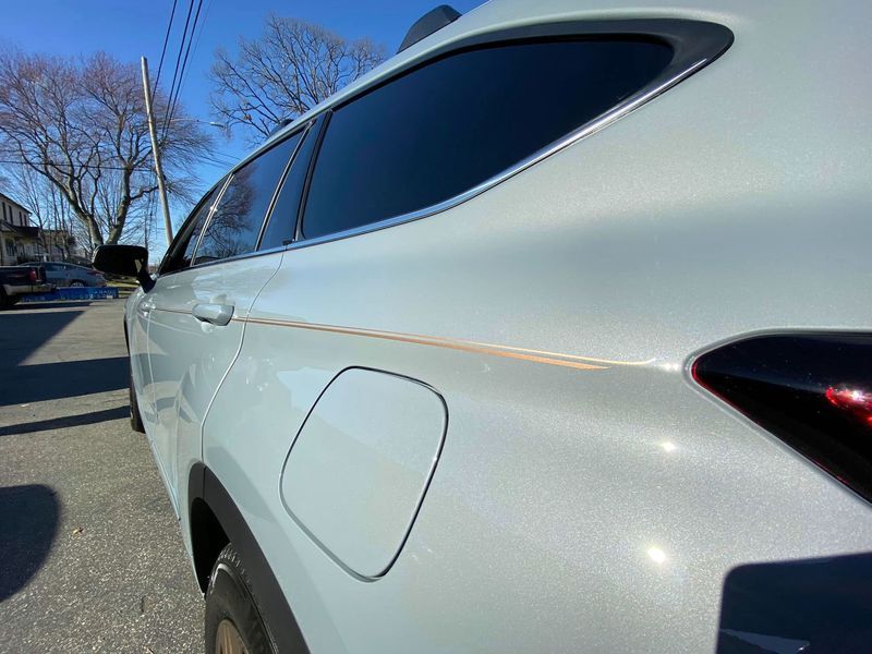 A white car is parked on the side of the road.