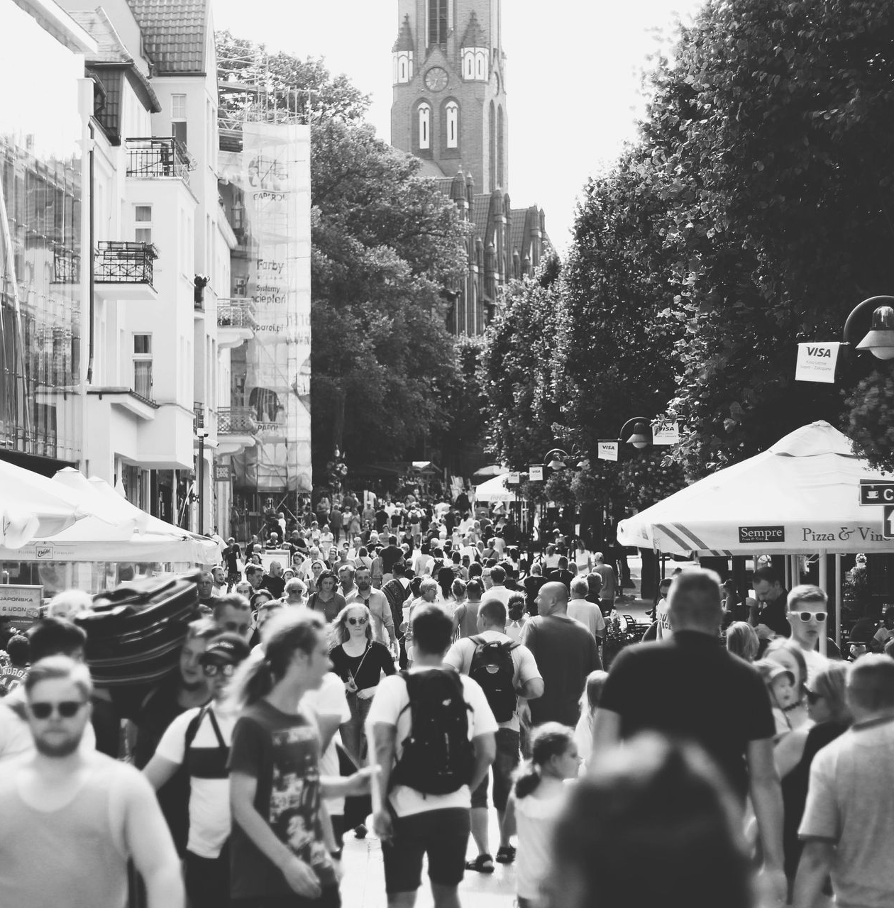 Pathway leading to a pier on a lake, trees with Spanish moss, blue sky and clouds.