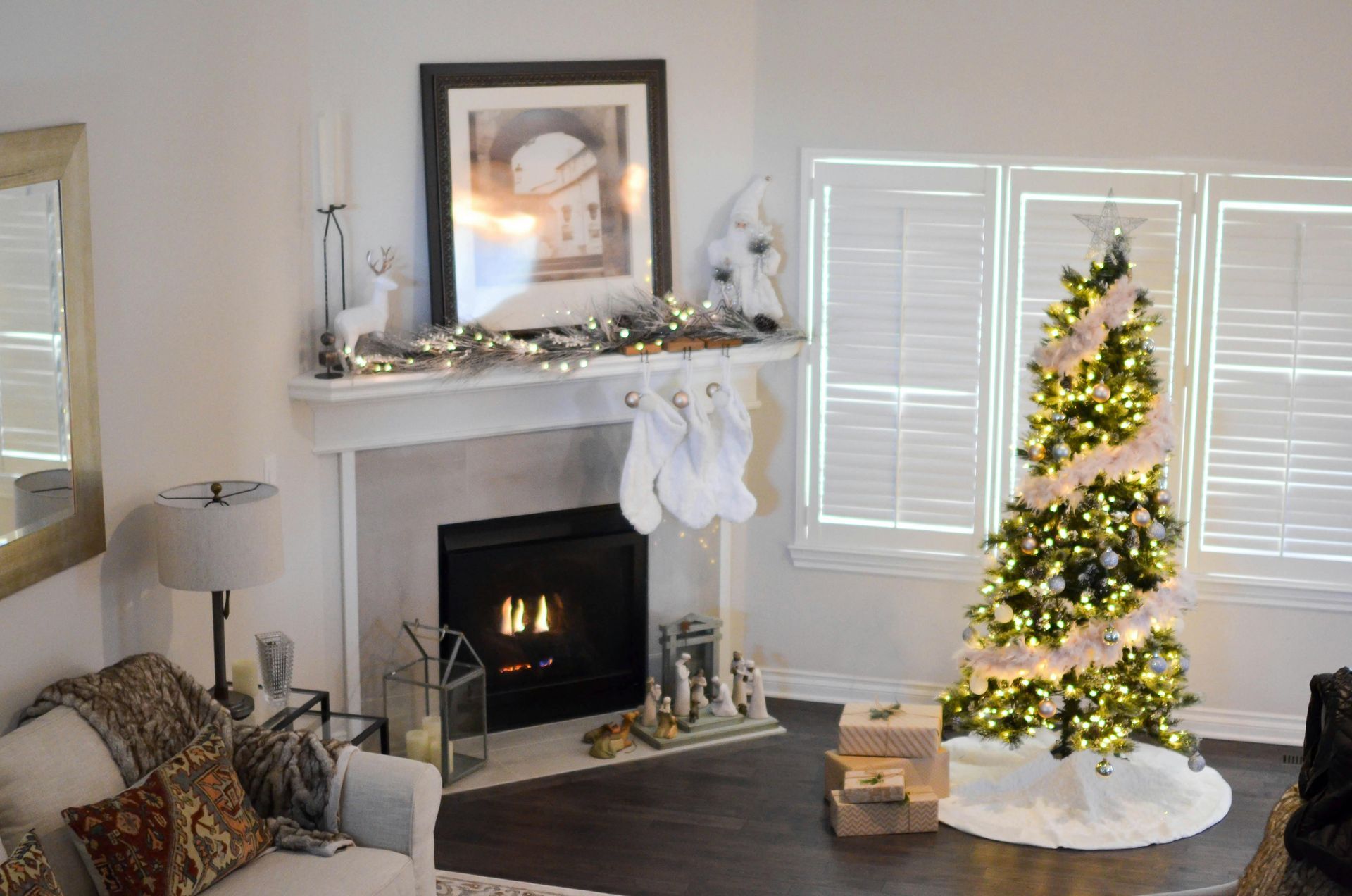 Living room with Christmas tree, fireplace, and decorations.