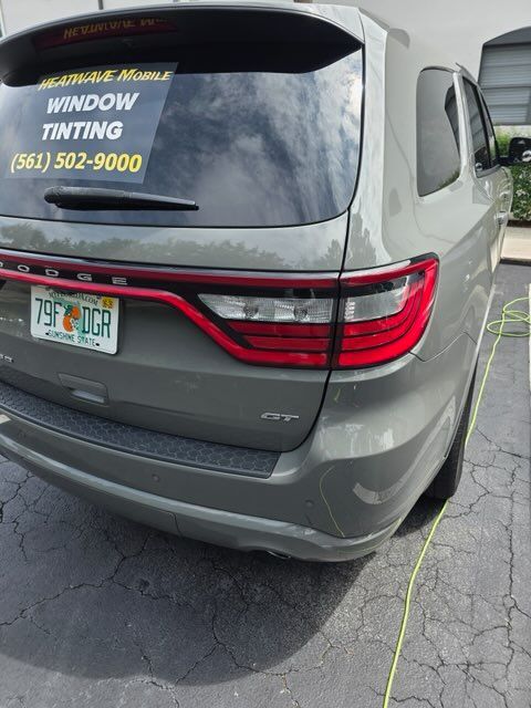 Rear view of a gray Dodge Durango with tinted windows and a Florida license plate.