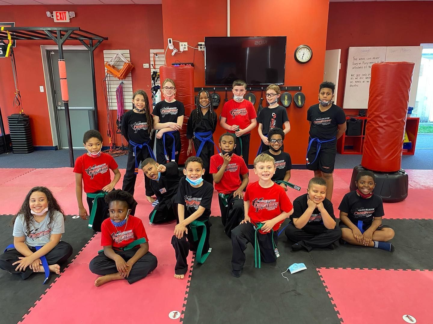 A group of children are posing for a picture in a gym.