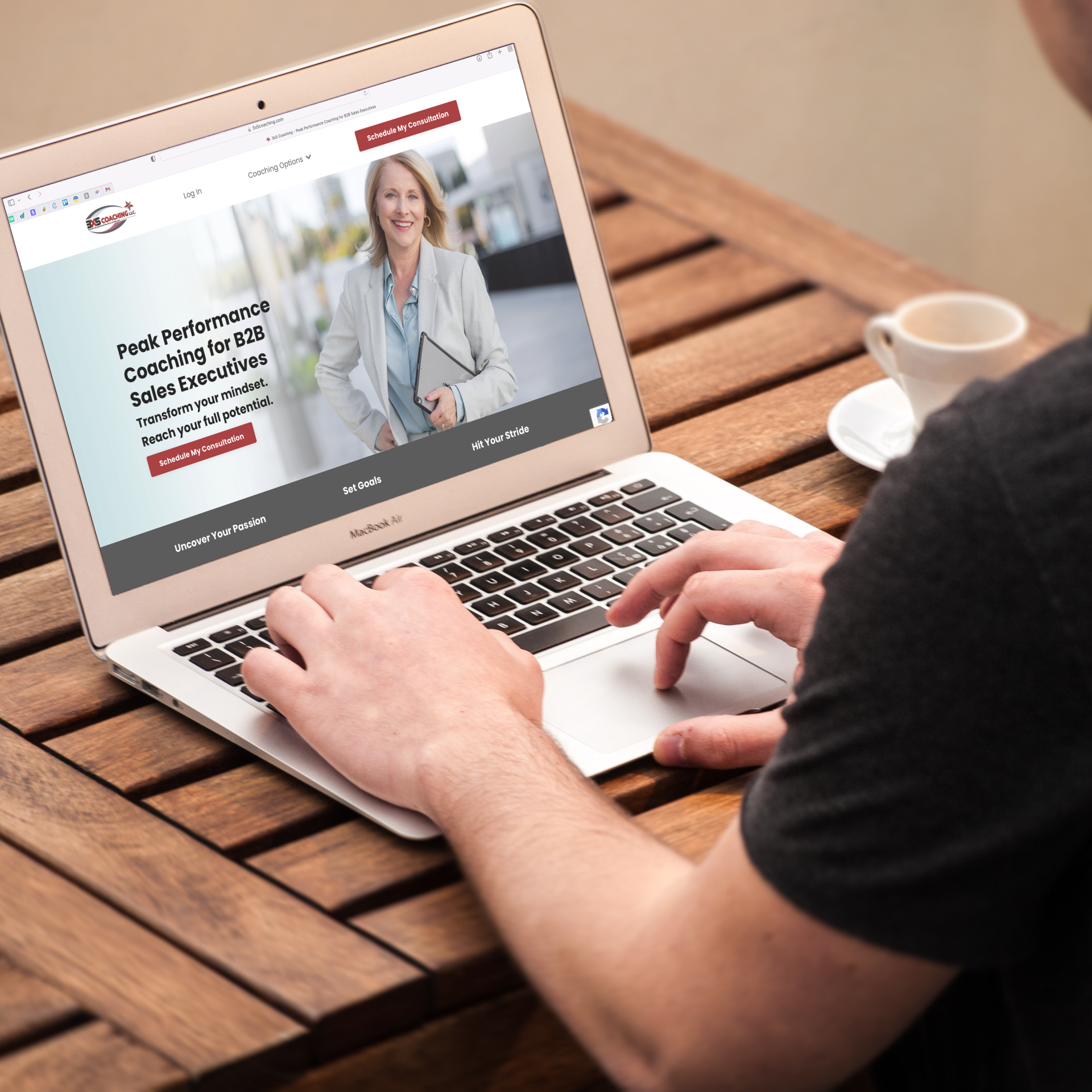 Woman typing on laptop top with 3x5 coaching website on the screen