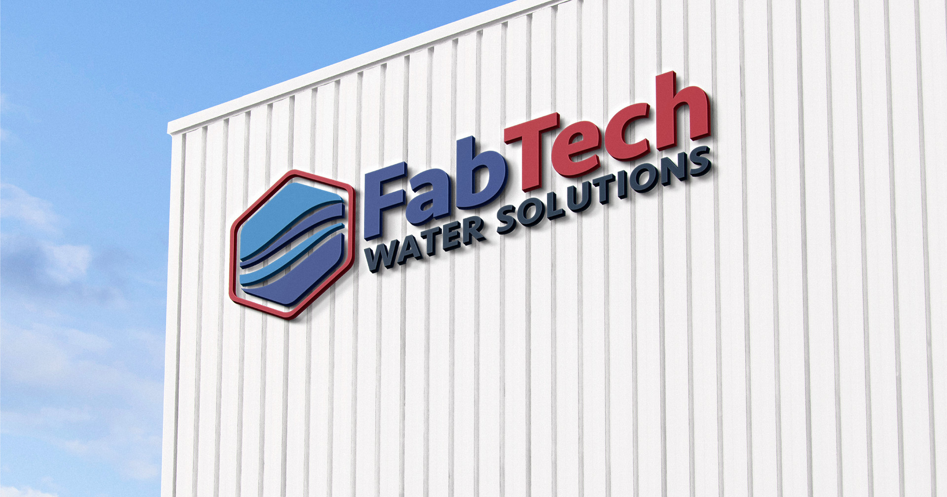 white metal building of manufacturing company with FabTech logo on the side