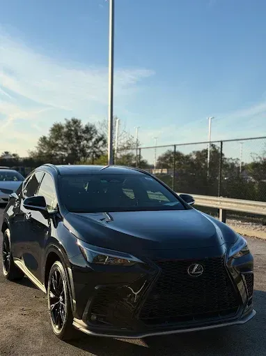 Black Lexus NX SUV parked outdoors on a sunny day.