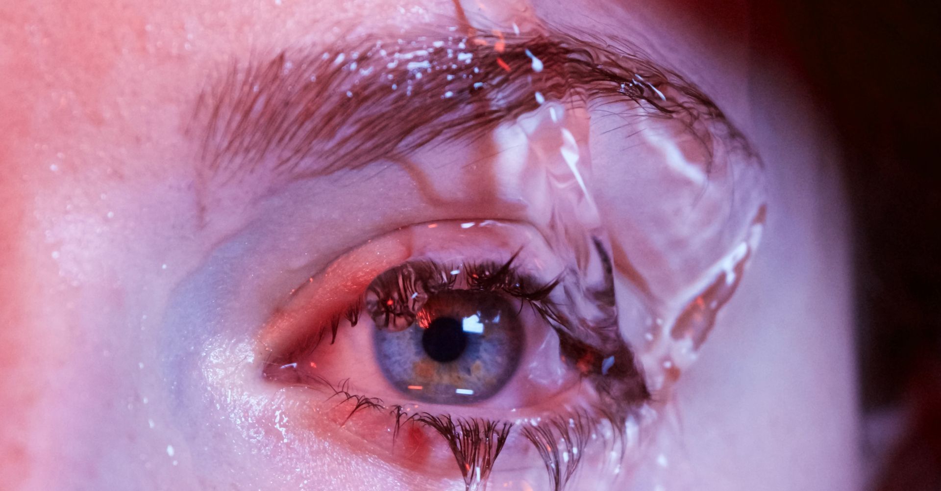 woman's eye with water falling on it