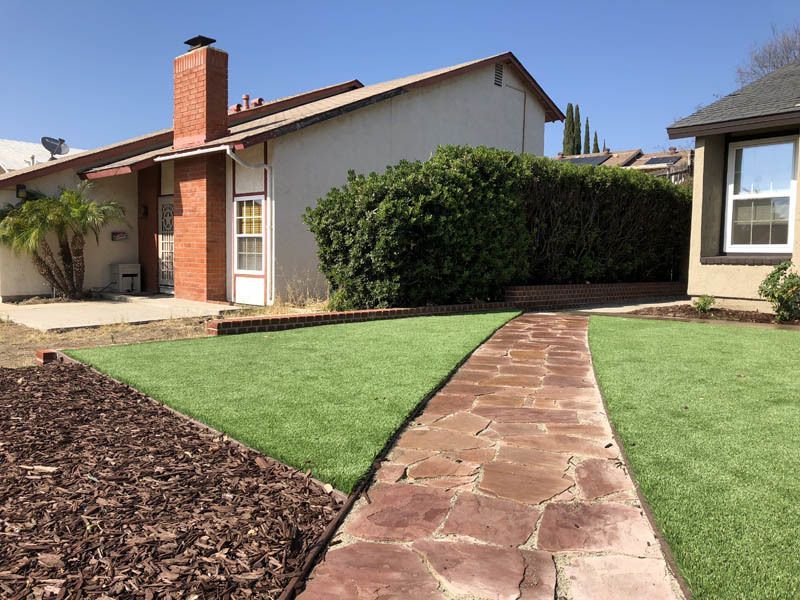 A house with a stone walkway leading to it