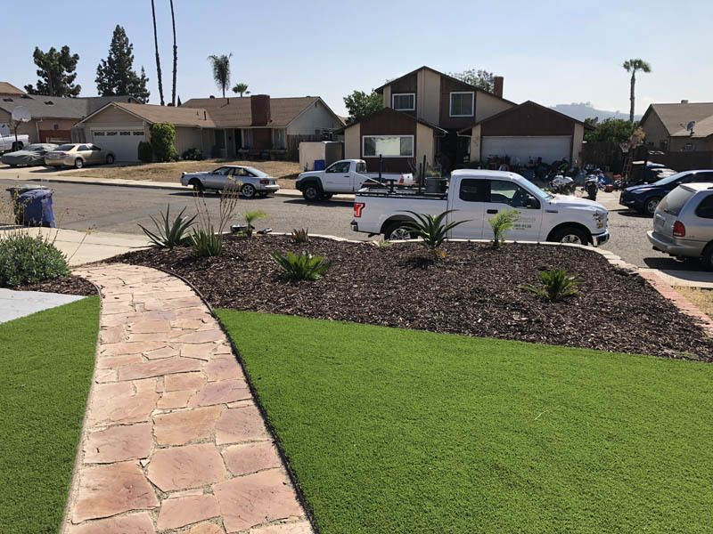 A white truck is parked in front of a house