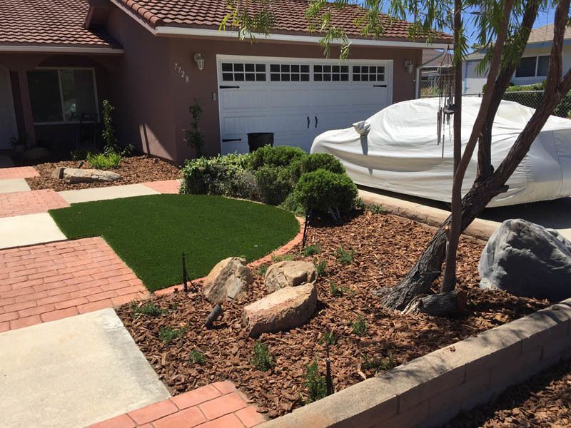 A white car is parked in front of a house