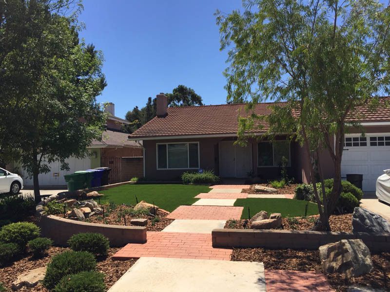 A house with a car parked in front of it